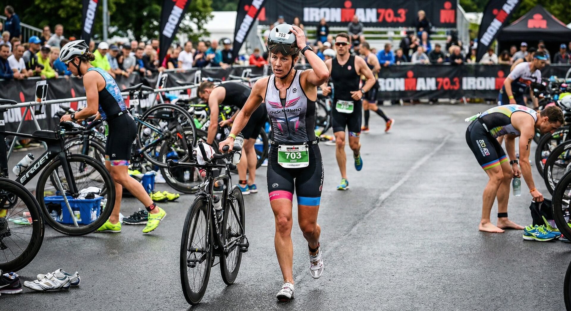 Triathlon athlete in transition zone switching from cycling to running — bib number on racing belt